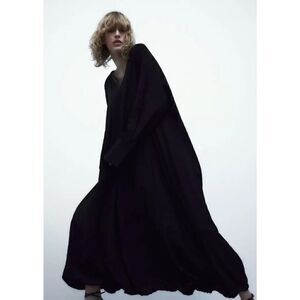 zara open back cape maxi dress The Zara Open Back Maxi dress features a high neck, open back with thin straps and a flattering silhouette. Perfect for fall and winter festivities and is under $90! #zara #fallfashion